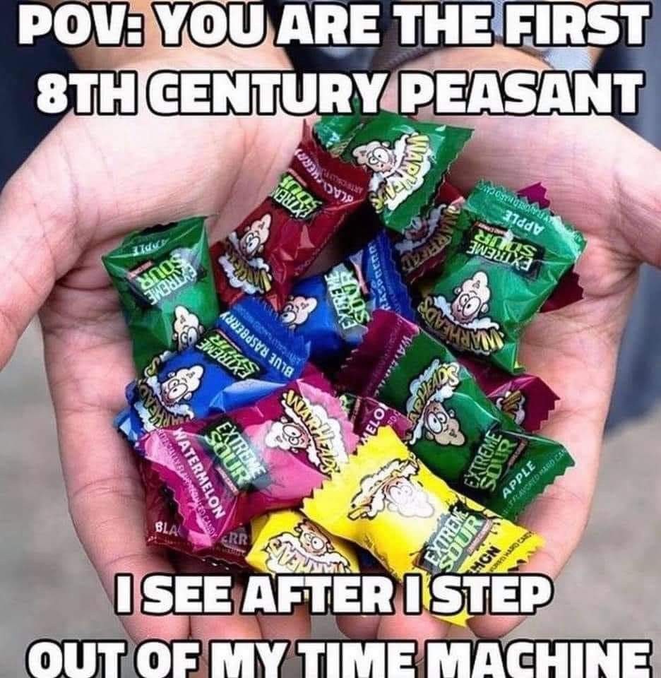 image of individually wrapped sour warhead candies in someone's hands. caption: "POV: you are the first 8th century peasant I see after I step out of my time machine"