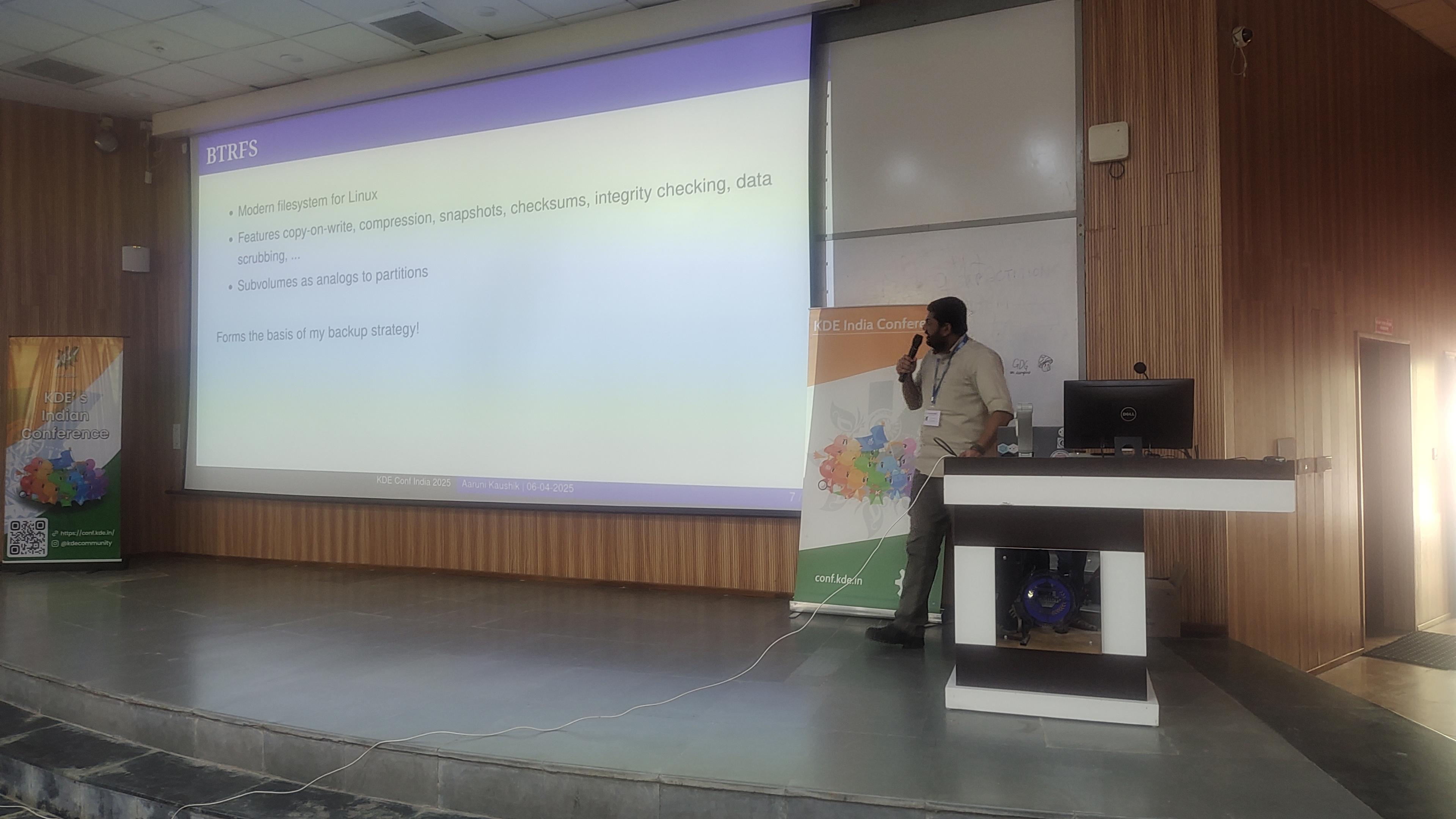 Speaker talking with slide giving information of btrfs